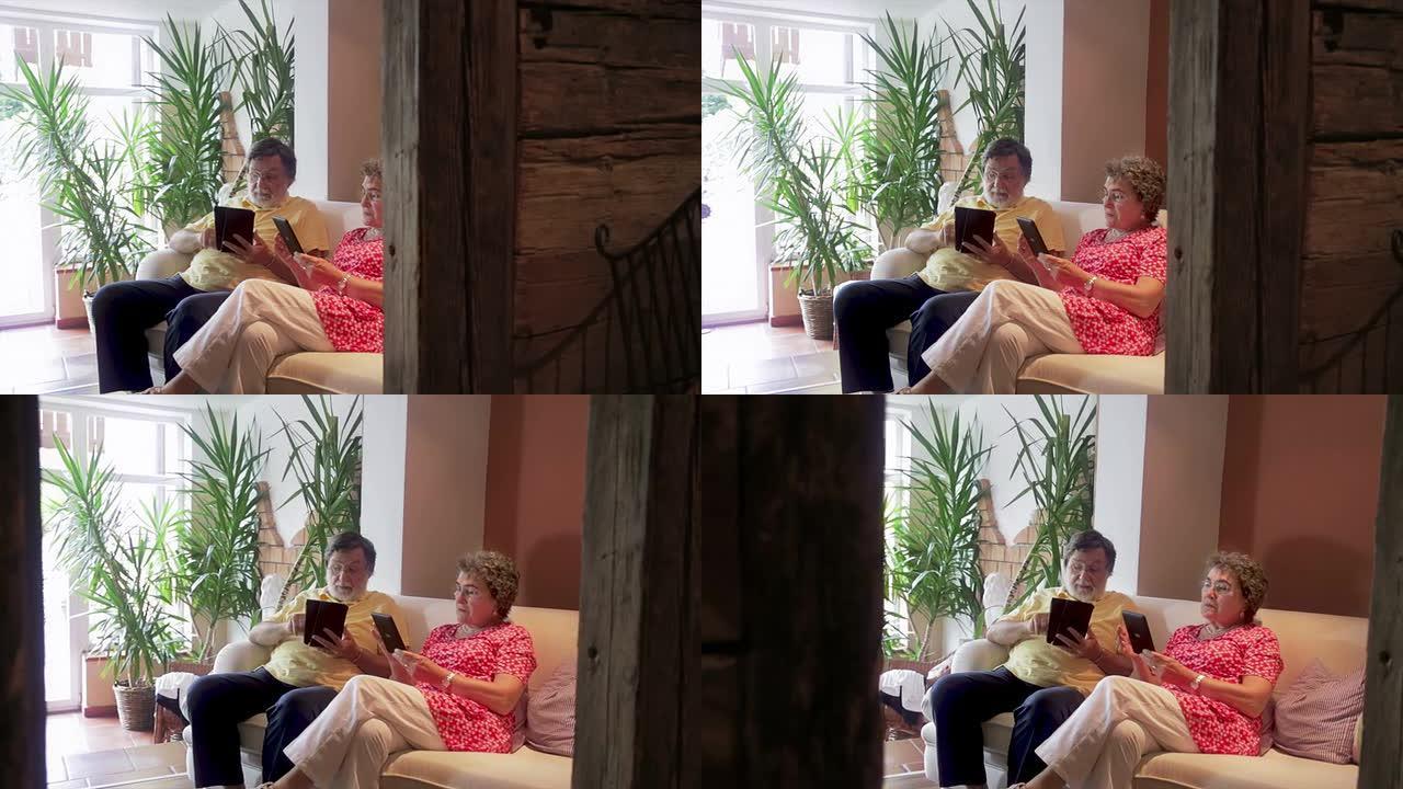 富有的高级夫妇正在家里阅读电子书