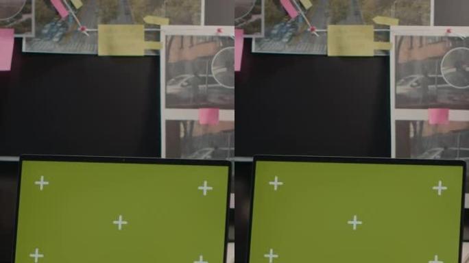 垂直视频: 带绿屏的现代笔记本电脑放在档案桌上