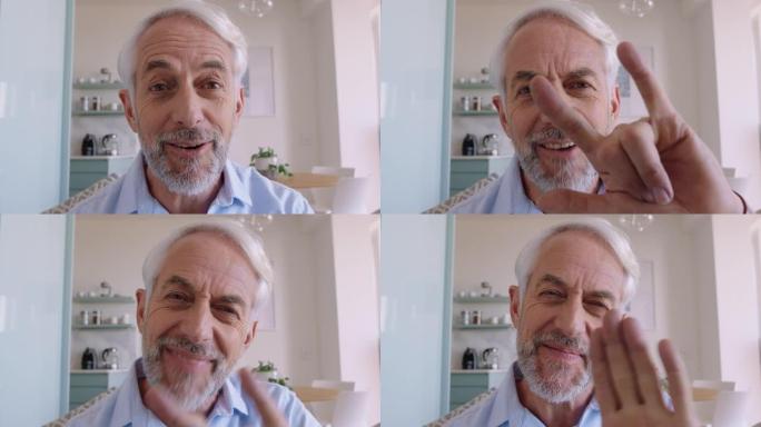 快乐的老人在家中使用网络摄像头上的手语进行视频聊天聋哑祖父聊天分享生活方式享受水平屏幕上的在线交流