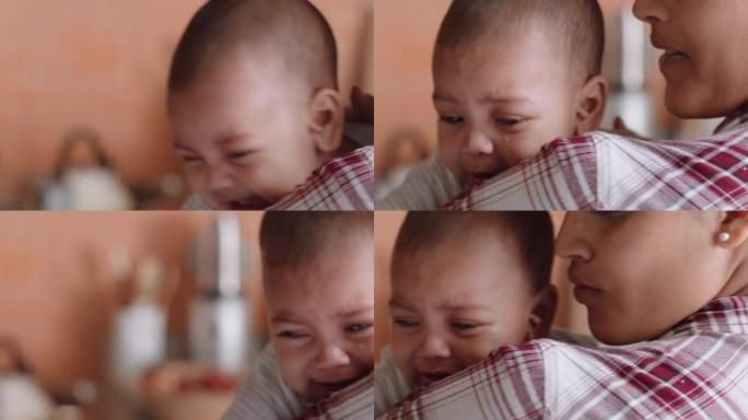 不快乐的婴儿在母亲肩膀上哭泣，婴儿尖叫着年轻的妈妈使疲倦的孩子平静下来