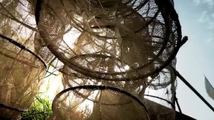篮子渔网悬挂晾干捕渔业特写镜头阳光光芒