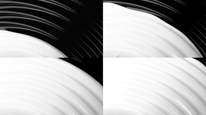黑色上的白色油漆流体流动