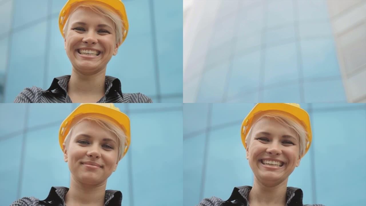 戴着头盔的女工程师的肖像对着镜头微笑