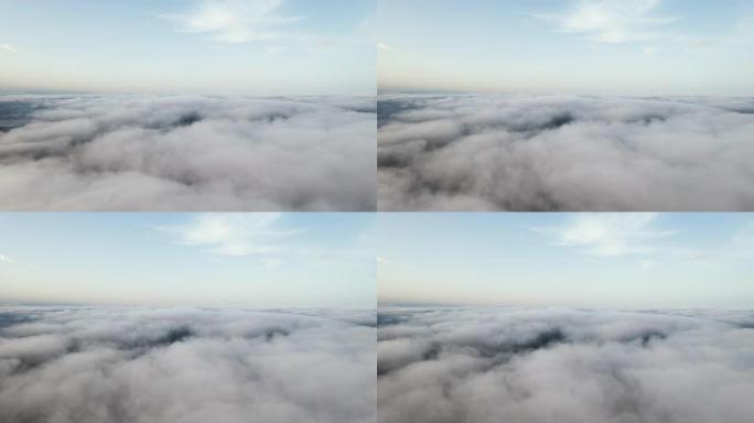 白云蓝天风景鸟瞰图移动。晚上，在明亮的阳光下，无人驾驶飞机在蓝天上飞过蓬松的云层。自然。雾