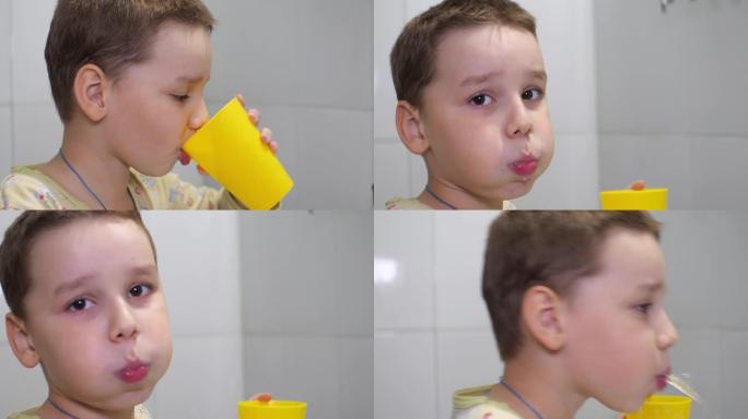 男童用牙刷刷牙后漱口。孩子用水用牙膏冲洗牙齿。在浴室里，男孩在水槽上漱口。