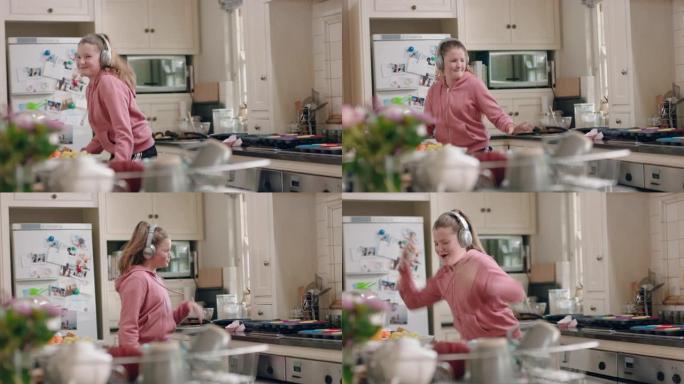 快乐的少女在厨房跳舞玩得开心庆祝周末表演有趣的舞蹈动作戴着耳机听音乐