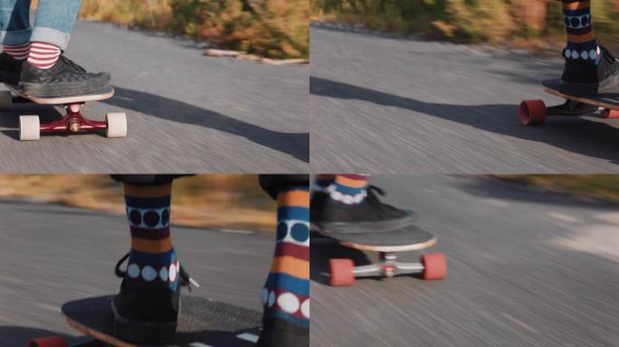 年轻朋友双脚长板一起骑下坡滑冰在乡村道路上快速使用滑板快乐的青少年享受户外巡航