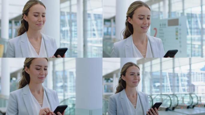 美丽的商业女性使用智能手机发短信走在公司办公室用手机打字短信检查电子邮件工作中成功的女性高管4k镜头