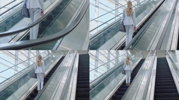 商务女性在自动扶梯上上班，在机场候机楼大堂上班，公司阶梯概念