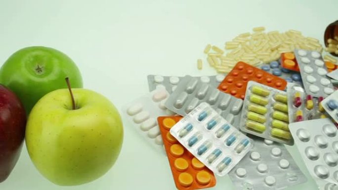 苹果和药丸的健康选择概念