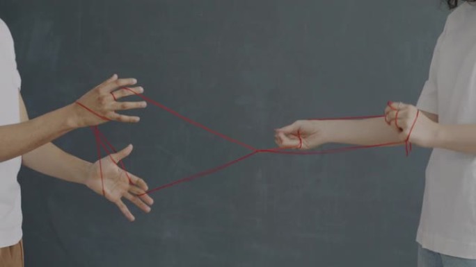 无法识别的女孩和男孩拉着绳子缠绕在手中，建立了对关系的控制
