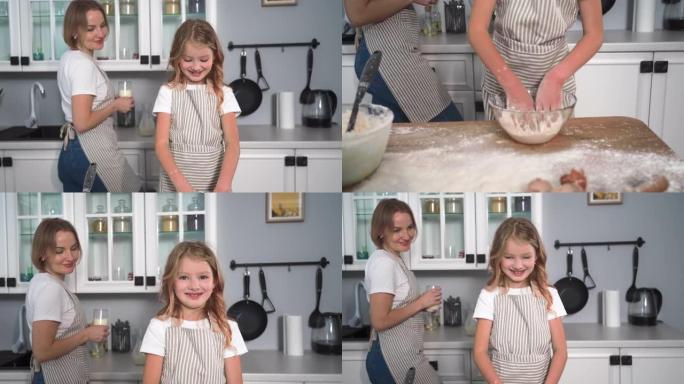 和孩子一起煮面团，女孩在碗里玩小麦粉，用一杯牛奶拍拍手母亲的背景，从棉花上溅出的面粉散落到两侧，孩子