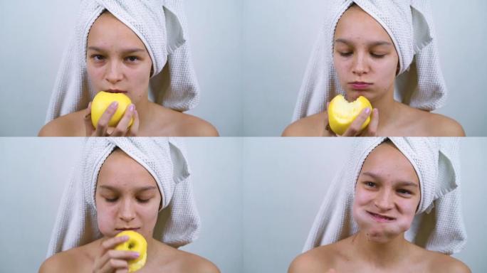 快乐的少女在浴巾吃苹果