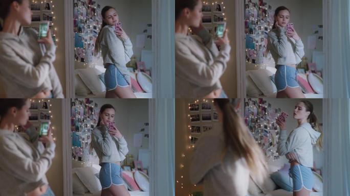 美丽的少女自拍照片使用智能手机在镜子里摆姿势在社交媒体上分享时尚时尚在家享受周末青少年自我形象