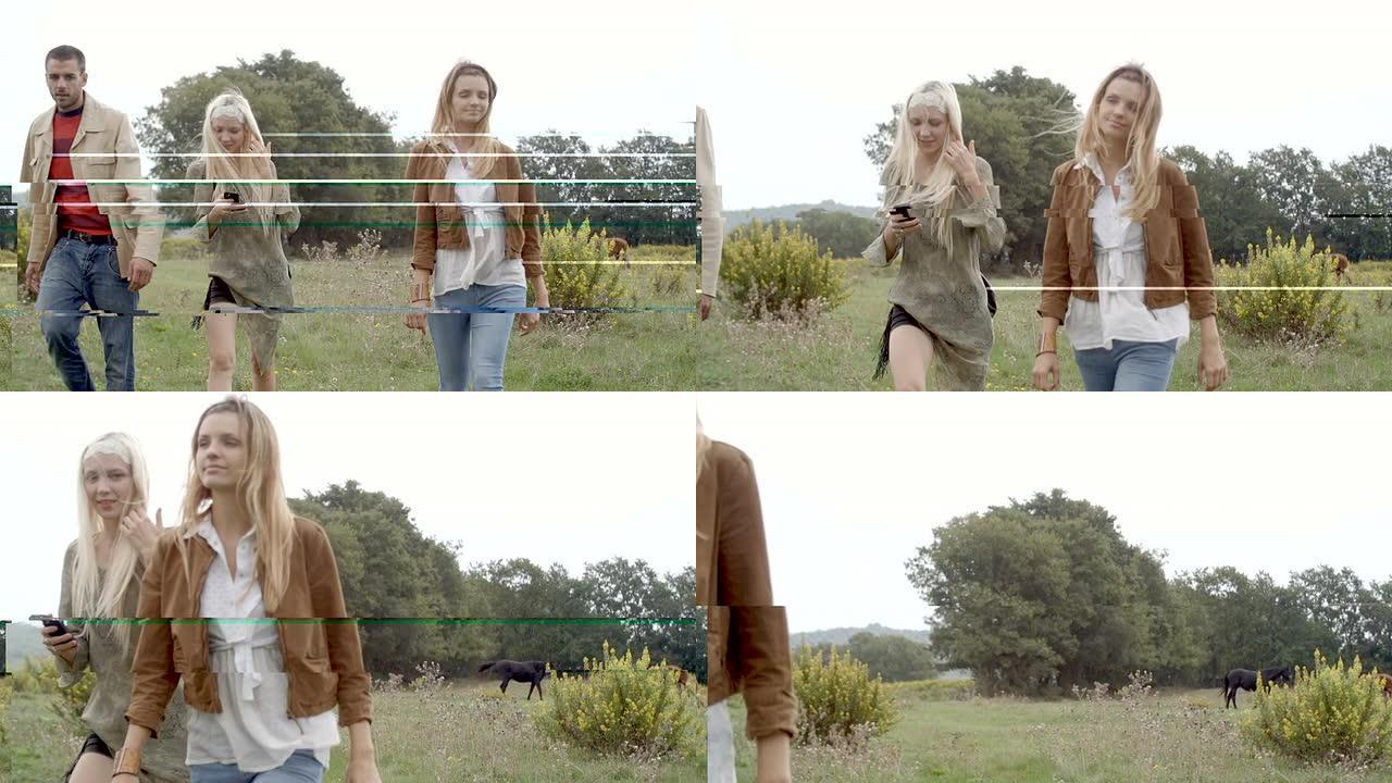 大自然中的三个朋友带着马走向相机 -- 慢动作高清视频镜头