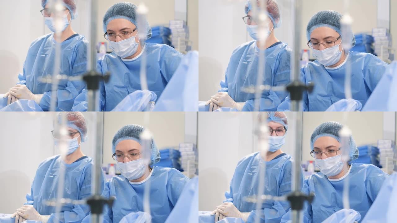 剖宫产手术是由穿着防护服的外科医生进行的。