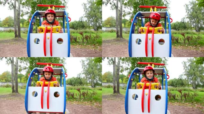 男孩在玩具直升机上秋千，儿童游乐场