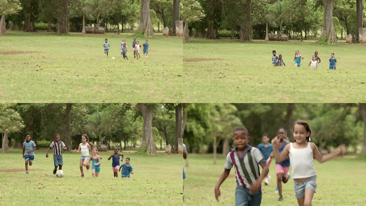 快乐的孩子在公园用球踢足球