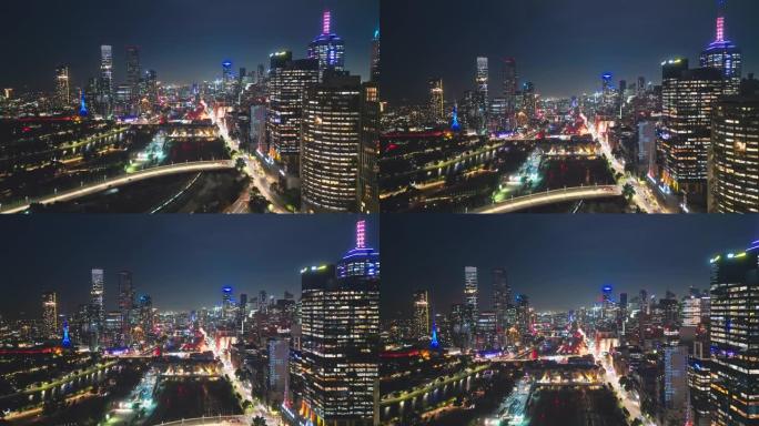 墨尔本城市中央商务区的4k鸟瞰图实时镜头，通过各种桥梁，现代办公楼和夜间的亚拉河，墨尔本