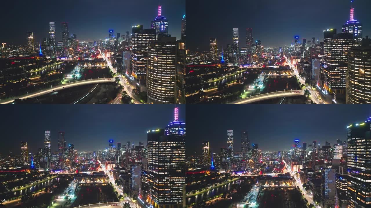 墨尔本城市中央商务区的4k鸟瞰图实时镜头，通过各种桥梁，现代办公楼和夜间的亚拉河，墨尔本