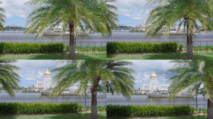 从文莱河可以看到，白天在文莱达鲁萨兰国斯里巴加湾市的苏丹奥马尔·阿里·赛义夫迪安清真寺，从公园和棕榈