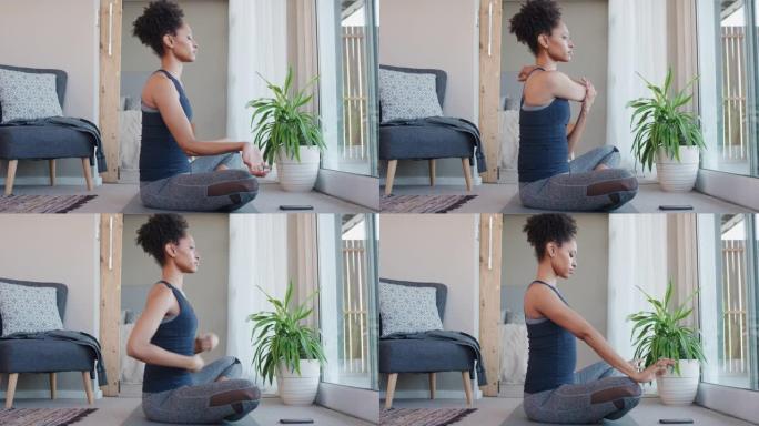 健康的非洲裔美国妇女在家锻炼，在客厅练习伸展运动，享受早晨健身锻炼