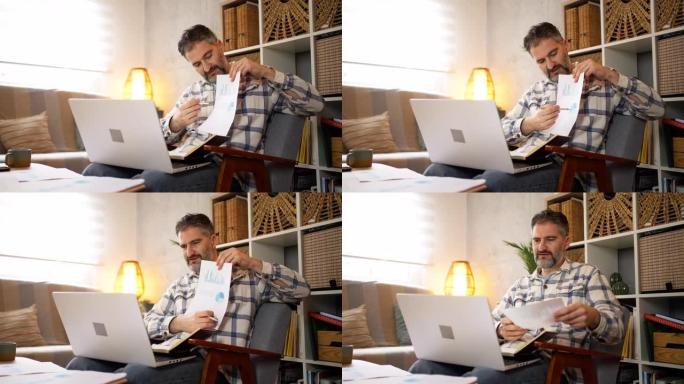 男子在家中使用笔记本电脑进行视频通话时，在文档上显示图表