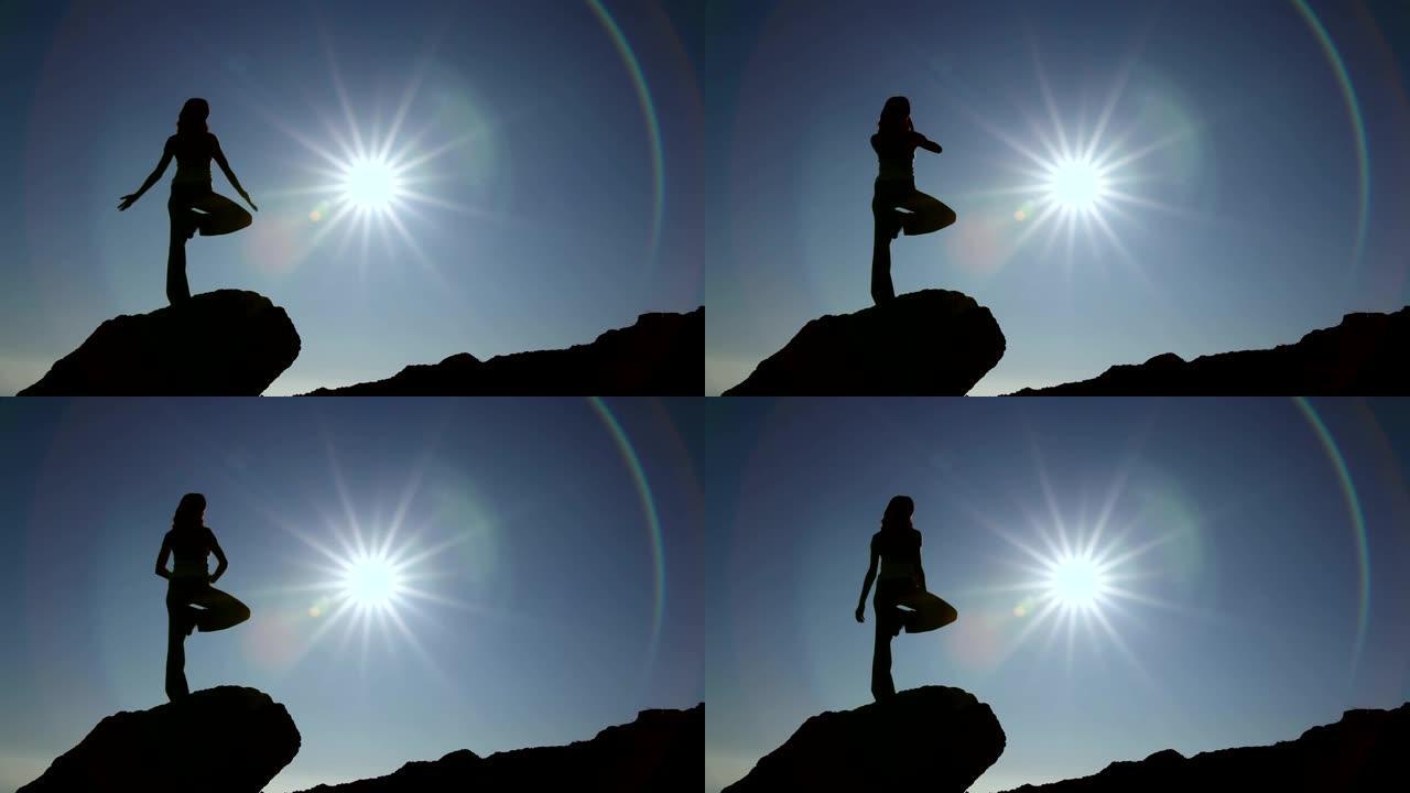 面向太阳练习瑜伽的女人的剪影