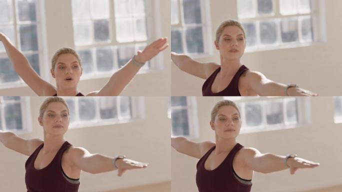 美丽的年轻白人女子练习瑜伽战士姿势锻炼教练展示姿势指导工作室健身课