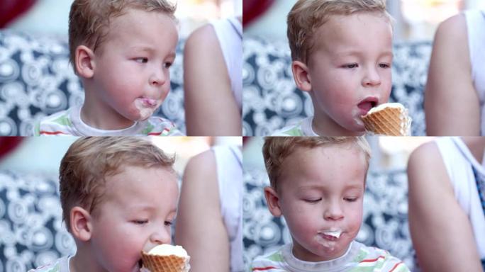 可爱的小男孩吃冰淇淋蛋卷