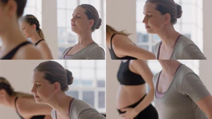 瑜伽课肖像年轻怀孕的白人妇女练习姿势抱着肚子享受健身工作室的集体锻炼
