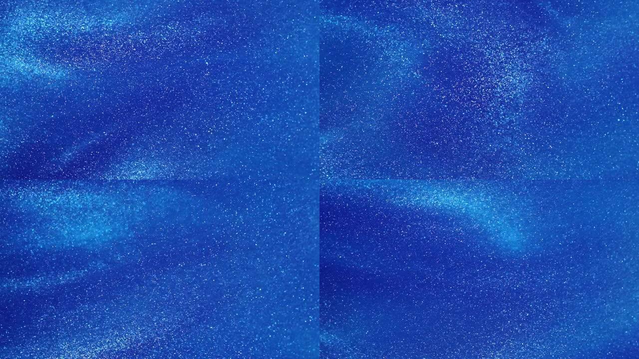 漂浮在蓝色液体中的白色发光尘埃颗粒。