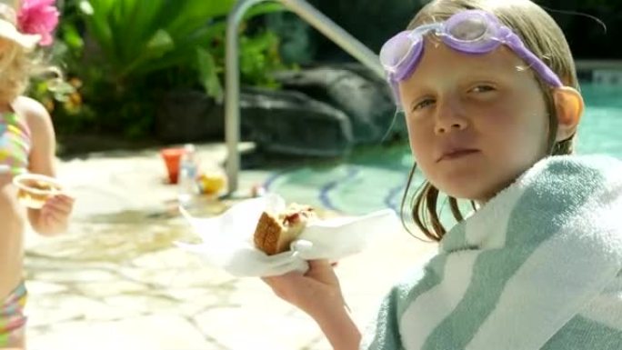 小女孩在游泳池吃零食