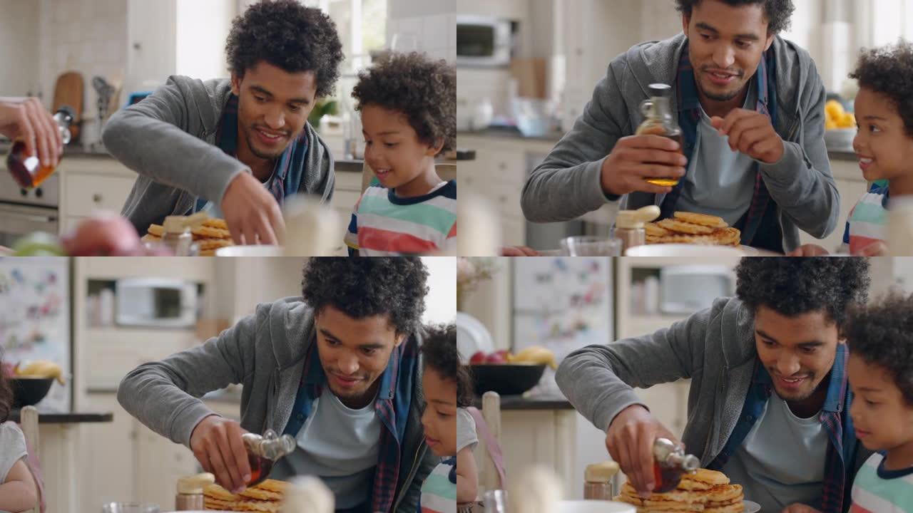 快乐的小男孩和家人一起吃新鲜的华夫饼早餐父亲倒蜂蜜在家厨房为儿子准备美味的自制食物4k