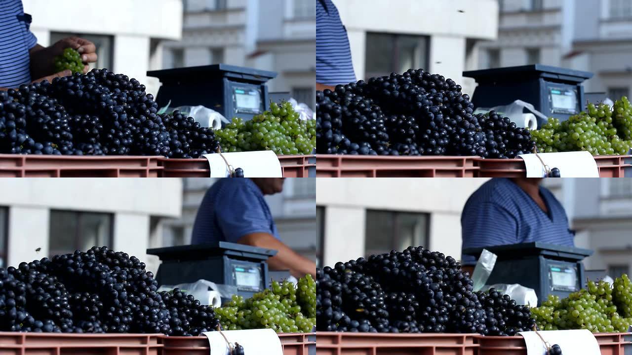 男人在市场上卖葡萄