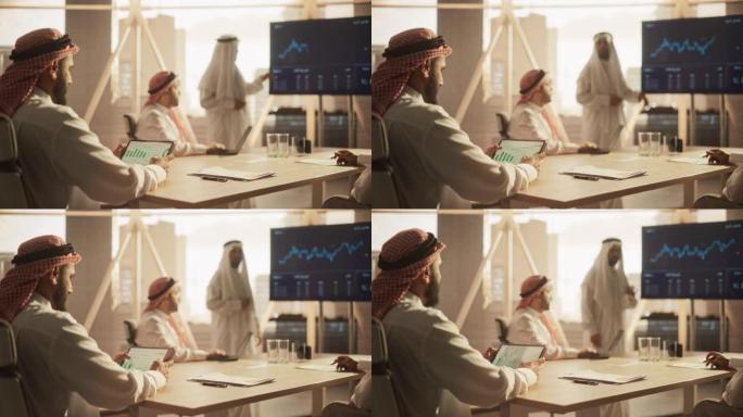 穆斯林商人在与公司合作伙伴的会议上使用平板电脑。经理在会议室听演讲时熟悉财务年度报告