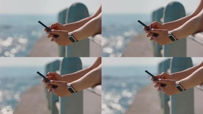 亲密的双手女人在社交媒体上使用美丽的海边智能手机分享暑假拍照