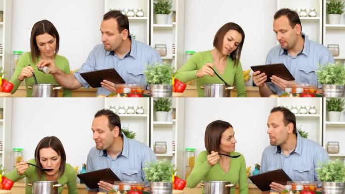夫妇在烹饪过程中使用平板电脑