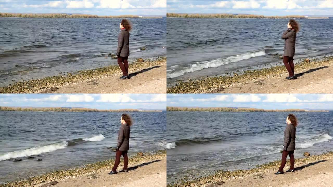 女人站在岸边，看着河