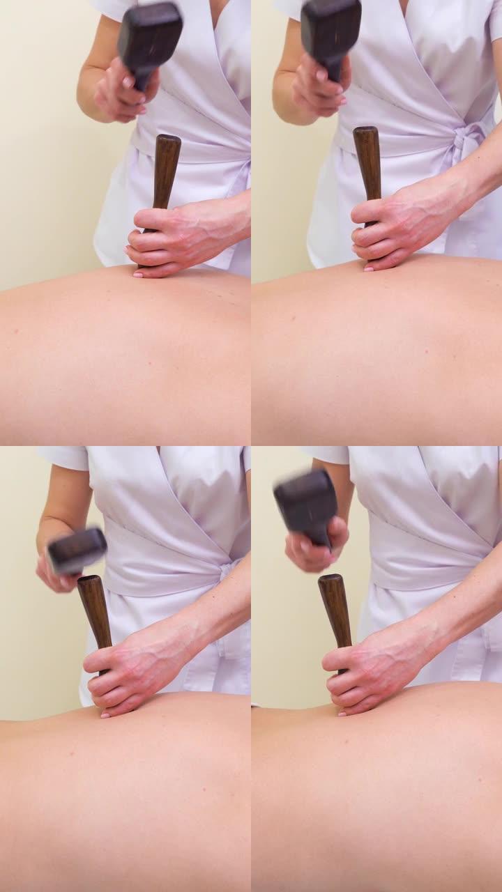 垂直: 女性治疗师在男性背上进行传统的泰国tok sen按摩