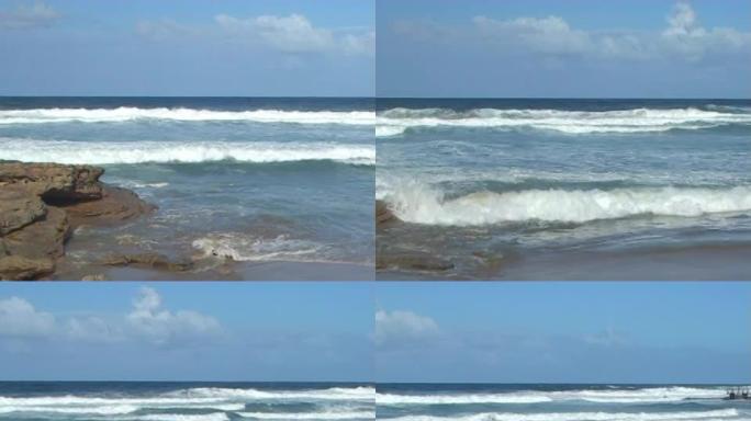 向右转的海洋岩石、海浪和游泳海滩