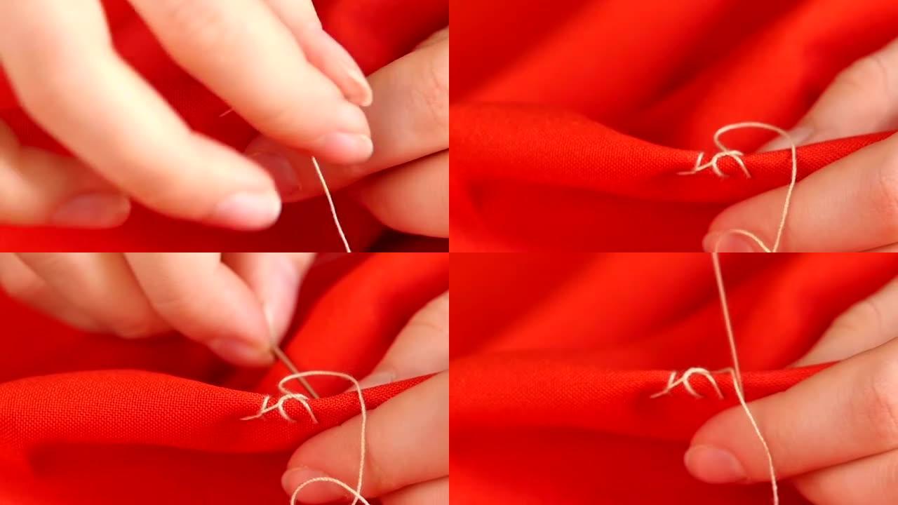 女人的手用针、白线和红布上的顶针缝制，特写，慢动作