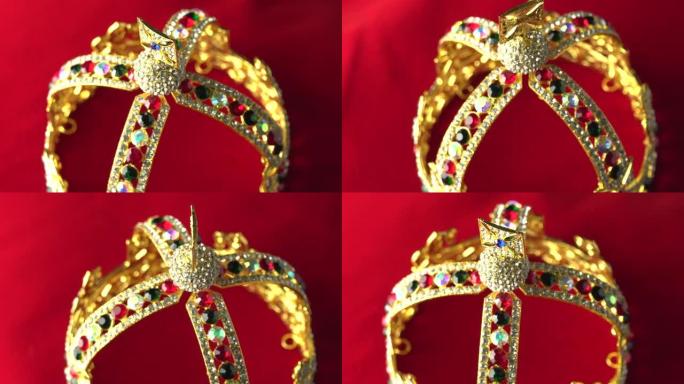 金色皇冠配豪华彩色珠宝和钻石。有反射和灯光火花。在红色皇家色表面上缓慢旋转。4k，uhd。专注于顶部