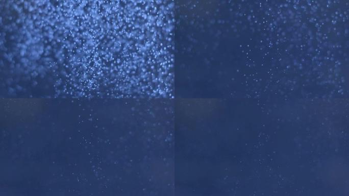 深蓝色水下海洋拍摄，气泡与墨水混合向下移动，到相机和向上移动抽象背景