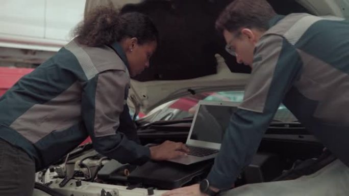汽车机械师检查和维护，以维修车间的发动机汽车。