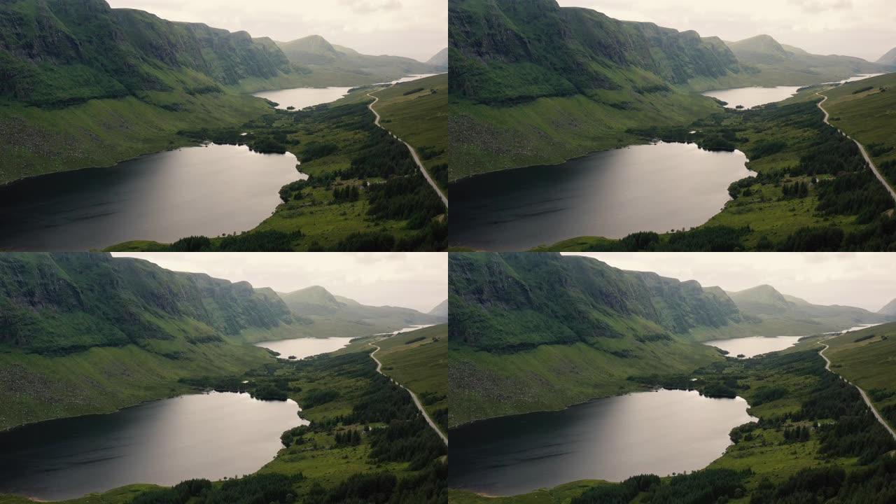 挪威绿色山丘上风景秀丽的湖泊之路的航拍画面