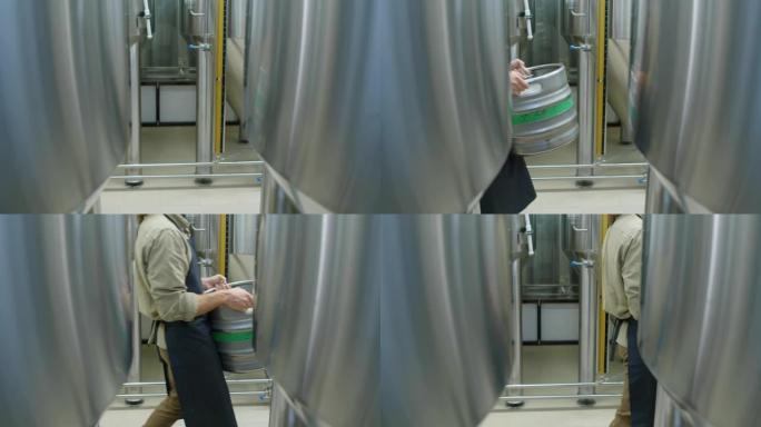 匿名男性啤酒厂工人提满啤酒桶