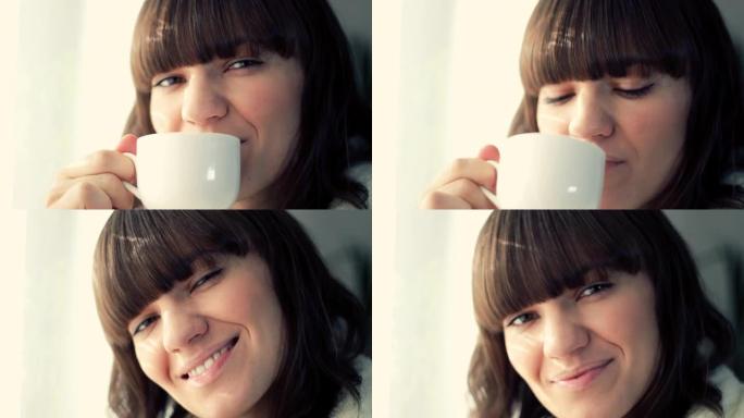 年轻微笑的女人喝杯茶