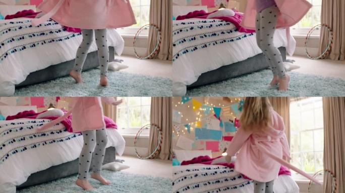 快乐的小女孩在卧室跳舞，早上穿着睡衣在家享受周末