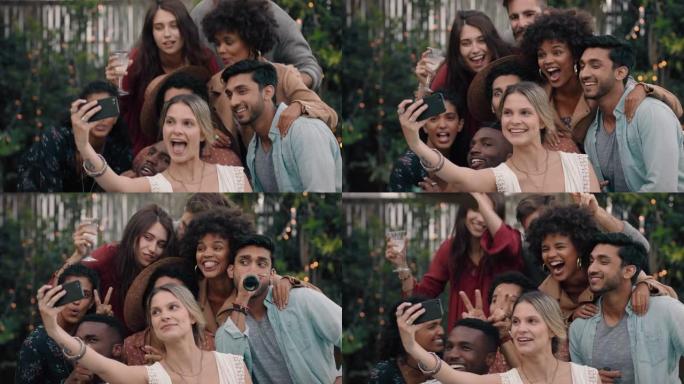 一群快乐的朋友用智能手机摆姿势拍照，庆祝友谊享受晚宴庆祝活动，一起在社交媒体上分享团圆周末